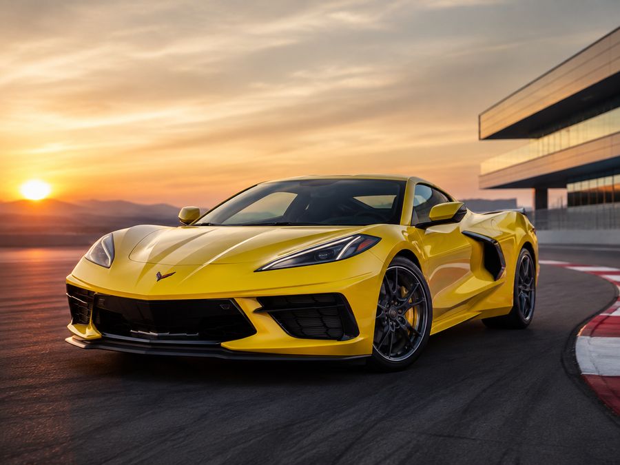 Yellow sports car on a race track at sunset