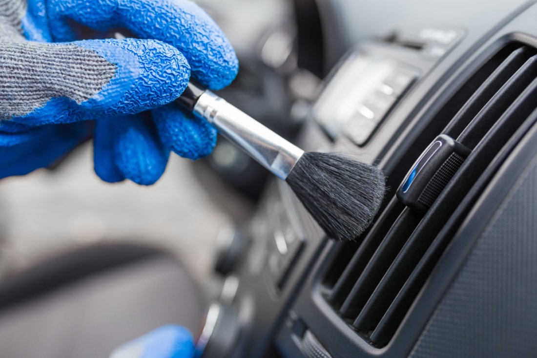 Detail brush cleaning dust from an air conditioning vent
